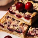 a stack of fresh cherry cheesecake bars