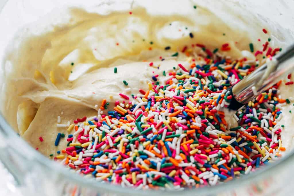 process shot mixing sprinkles into cake batter