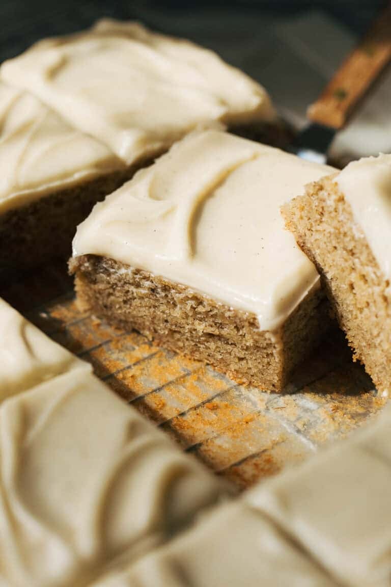 a slice of banana cake with cream cheese frosting