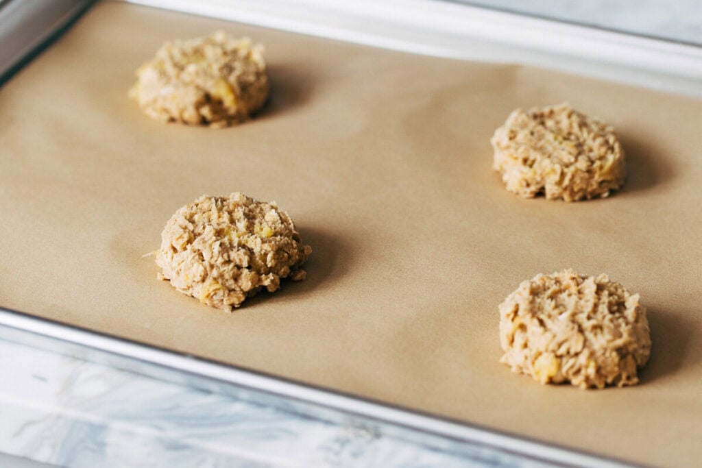 process shot of apple cookie dough on a baking sheet