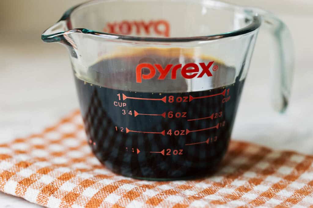 process shot of burnt sugar syrup in a measuring cup