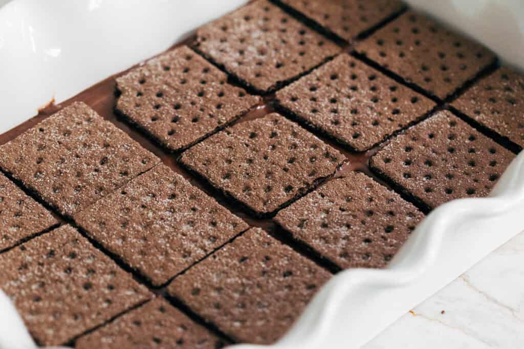 process shot layering chocolate graham crackers on chocolate pudding