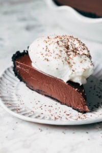 sliced chocolate pie topped with whipped cream