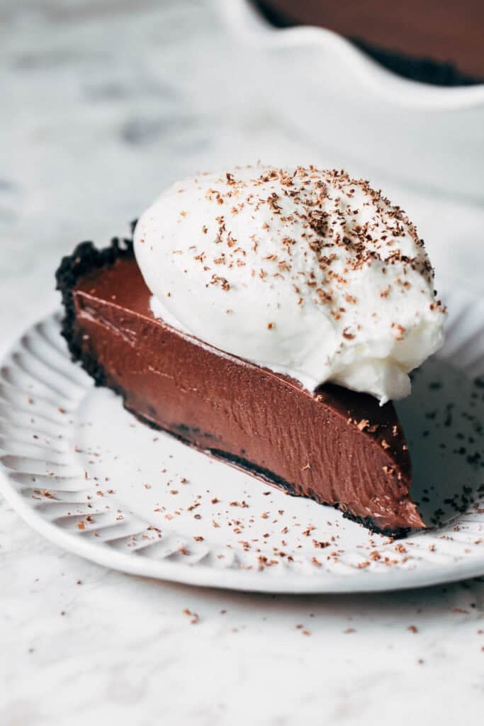 sliced chocolate pie topped with whipped cream