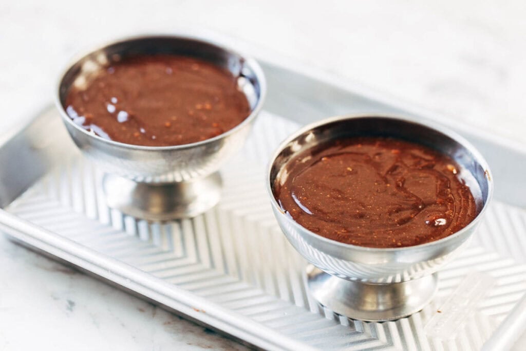 process shot of lava cake batter in ramekins