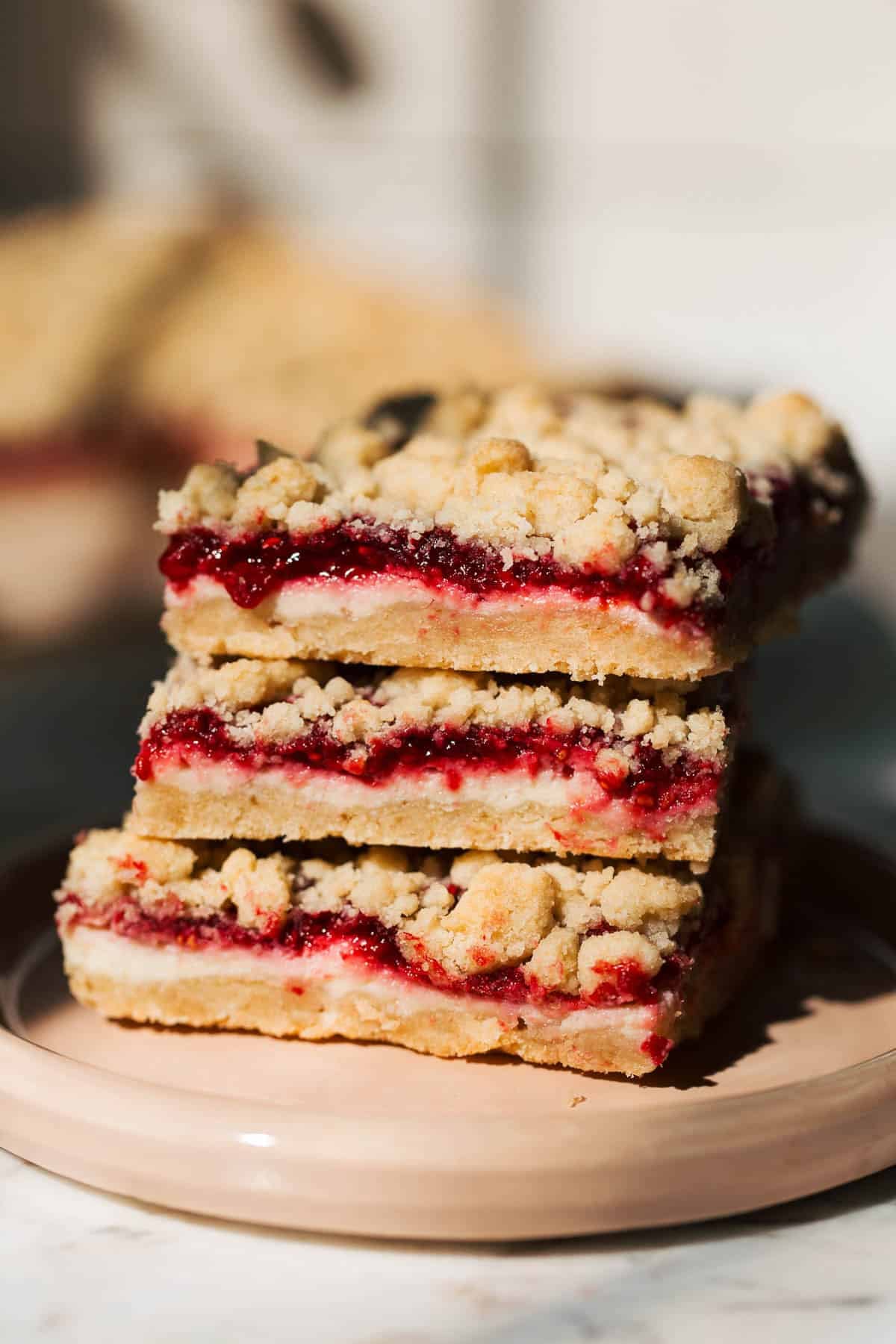 stacked raspberry cheesecake crumble bars