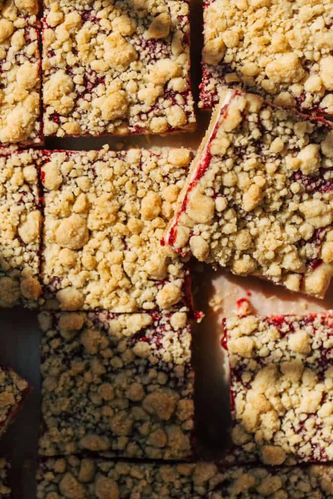 overhead shot of sliced raspberry cheesecake crumble bars