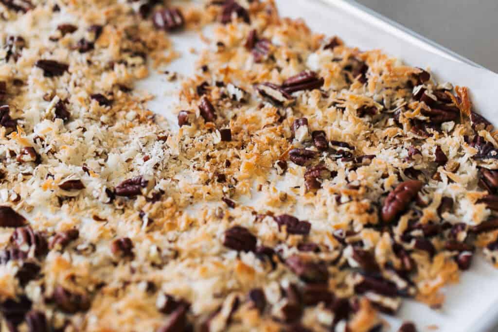 process shot toasting shredded coconut and pecan halves