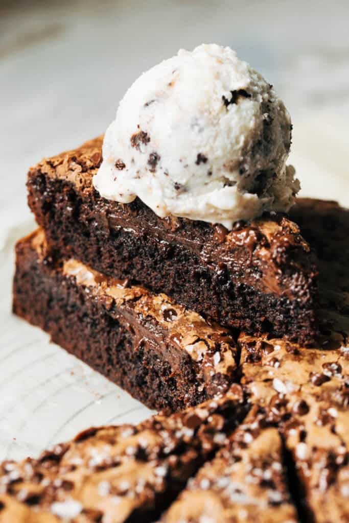 stacked brownie batter butter cake slices topped with ice cream