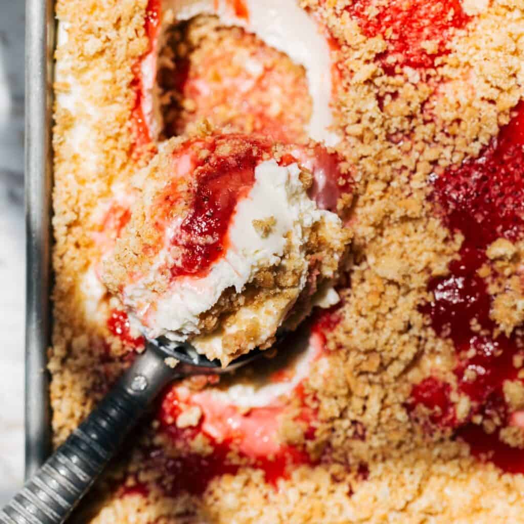 scooping into no bake cheesecake
