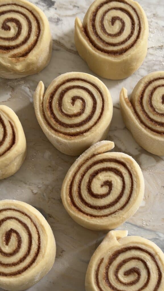 process shot of cut cinnamon roll dough